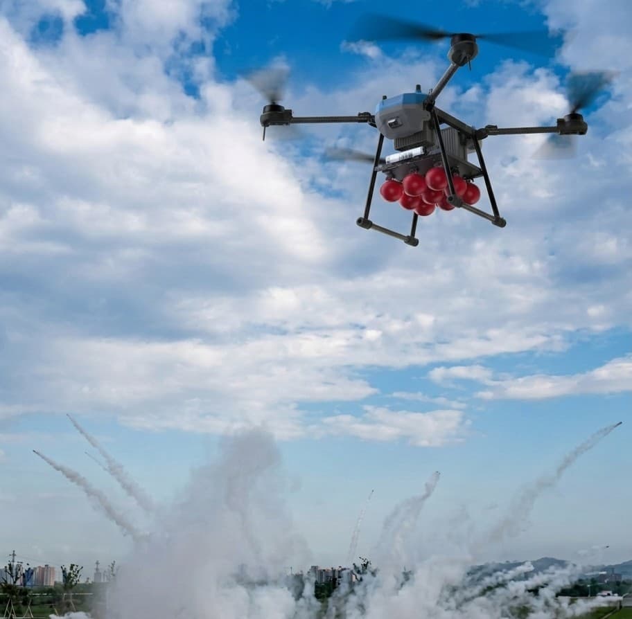 Firefighting drone releasing extinguishing balls over a fire